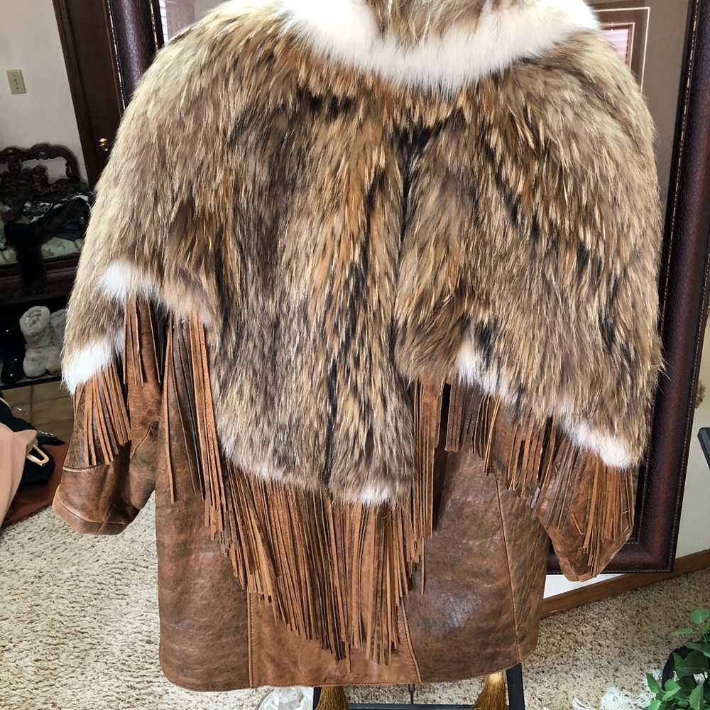 Stroller jkt with coyote fur on top half & leather on bottom half also fringe.